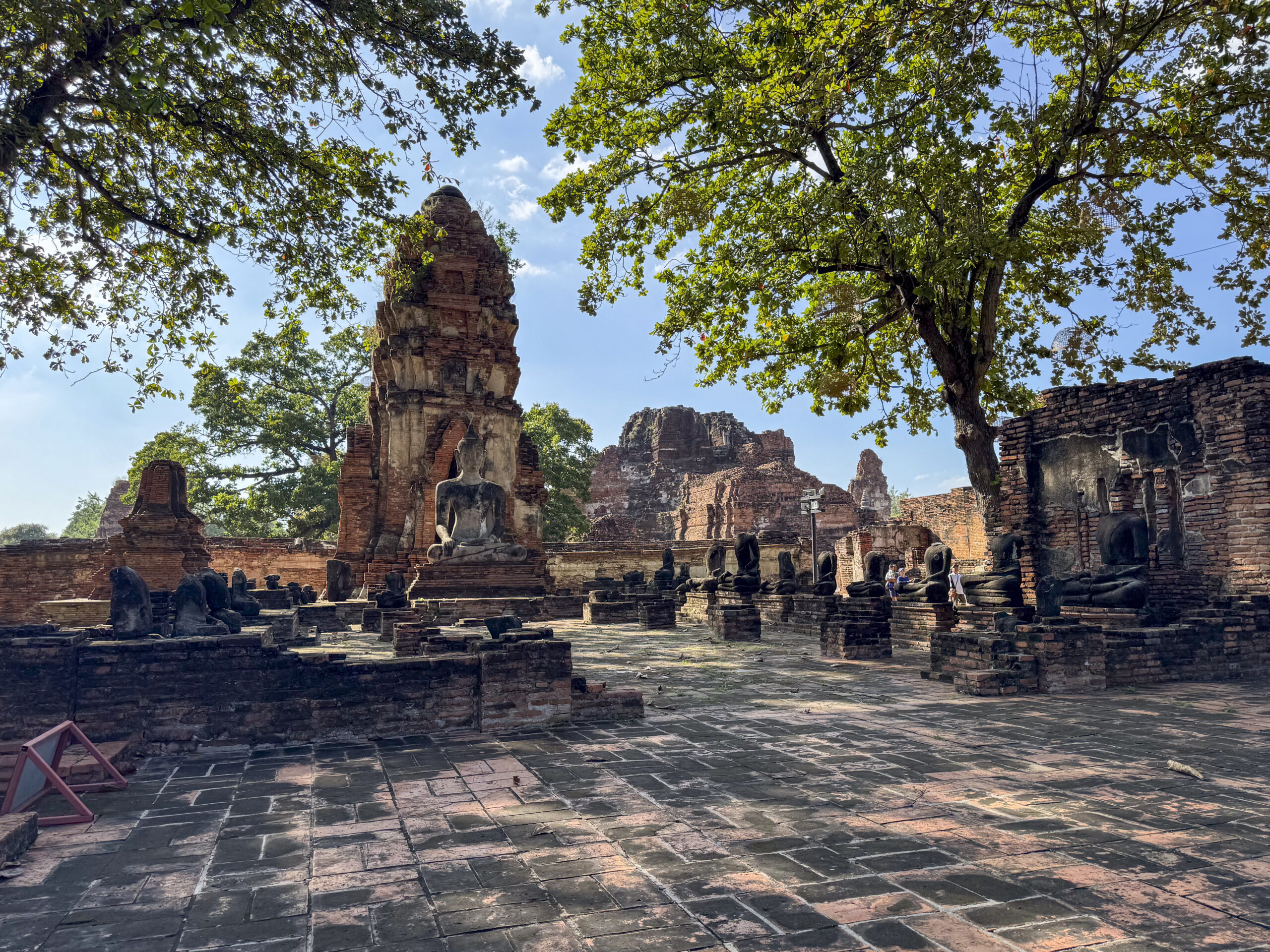 Spiritual Buddha statues outdoors at the old Thai temple landmark, Wat Maha That tourism. Ancient historical brick structures symbolizing peace and spirituality, famous Buddhist culture.
